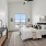 a bedroom with a bed and a mirror