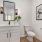 a bathroom with a toilet and a mirror