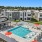 a swimming pool in front of a large white building