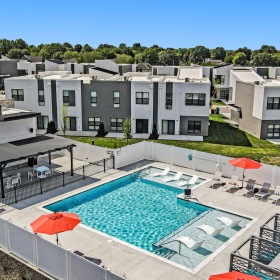 a swimming pool in front of a large white building