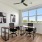 a room with a table chairs and a window