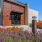 a building with a large garden of flowers in front of it