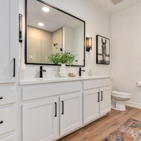a bathroom with white cabinets