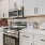 a kitchen with white cabinets