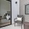 a room with a bed and chairs