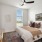 a bedroom with a bed and a fan