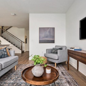 a living room with a tv and couches