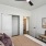 a living room with a ceiling fan and couches